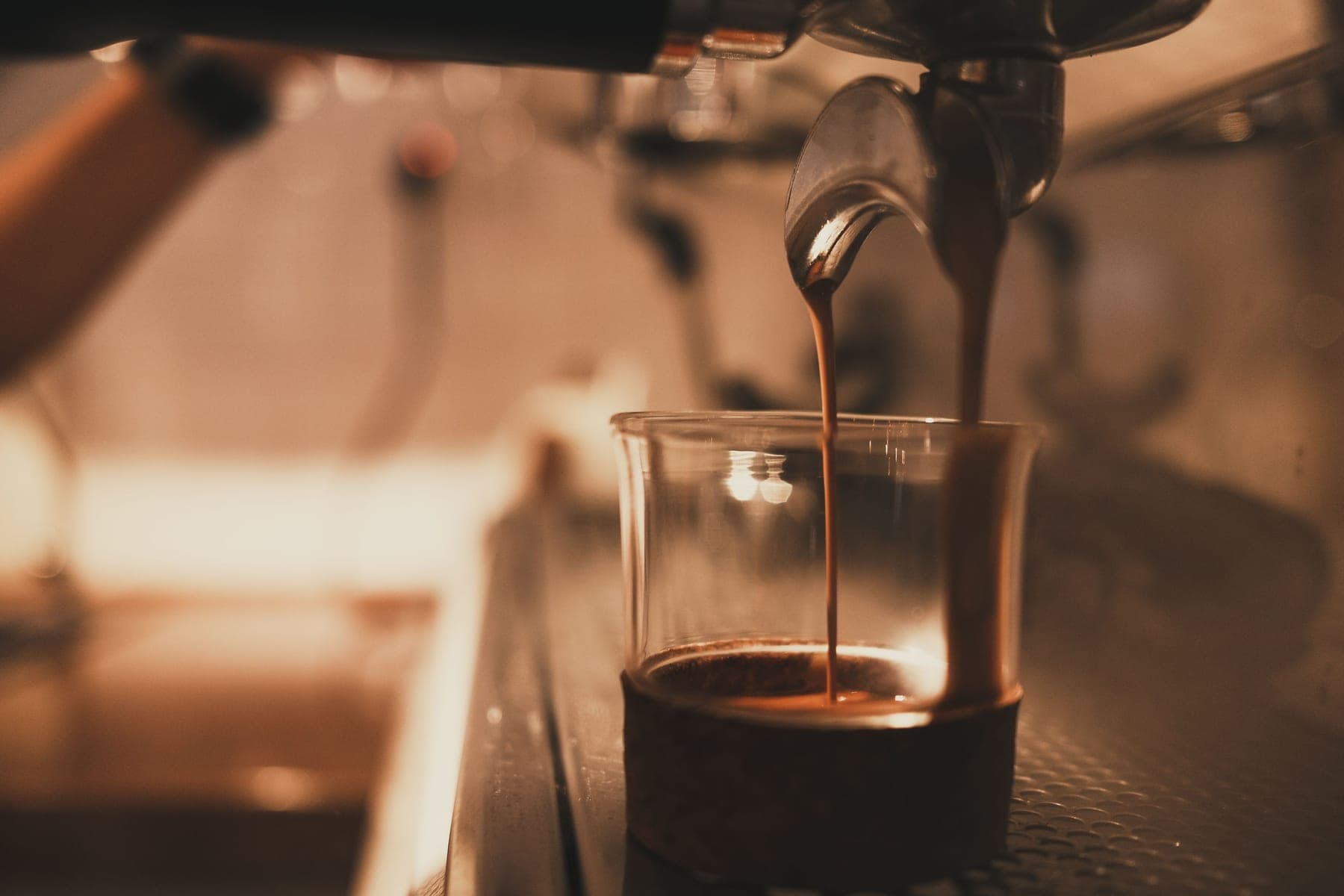 Espresso pouring from a machine into a glass